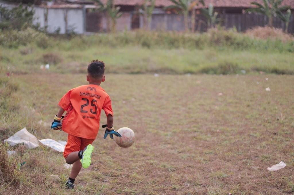 football, soccer, field, kicking the ball, game, indonesia, kid, school, student, sekolah sepak bola, outdoors, boy, athlete